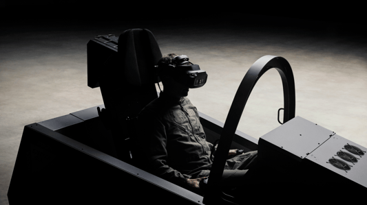 A person sitting in a flight simulator